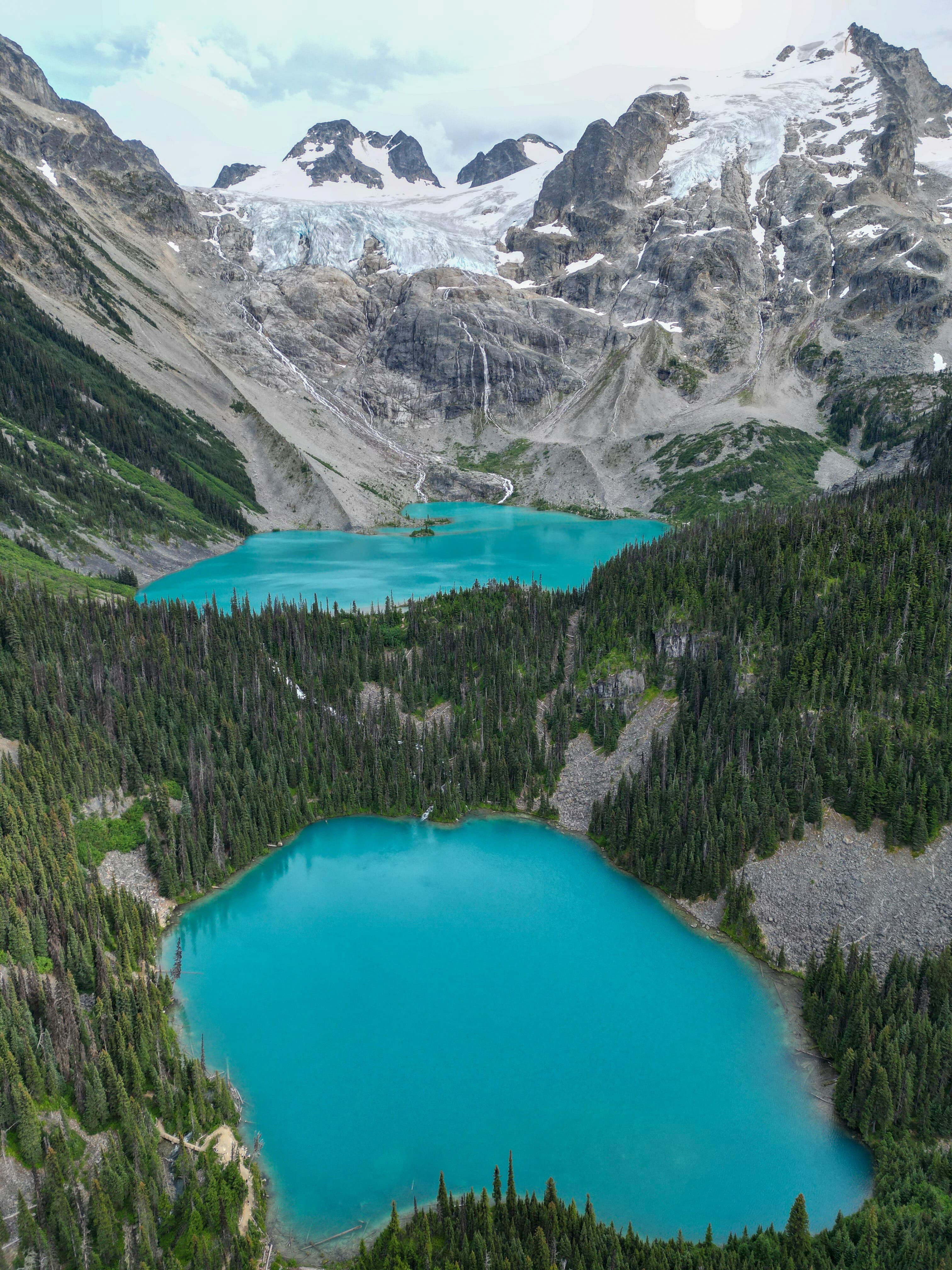 Aerial view of twin glacial turquoise lakes in British Columbia
