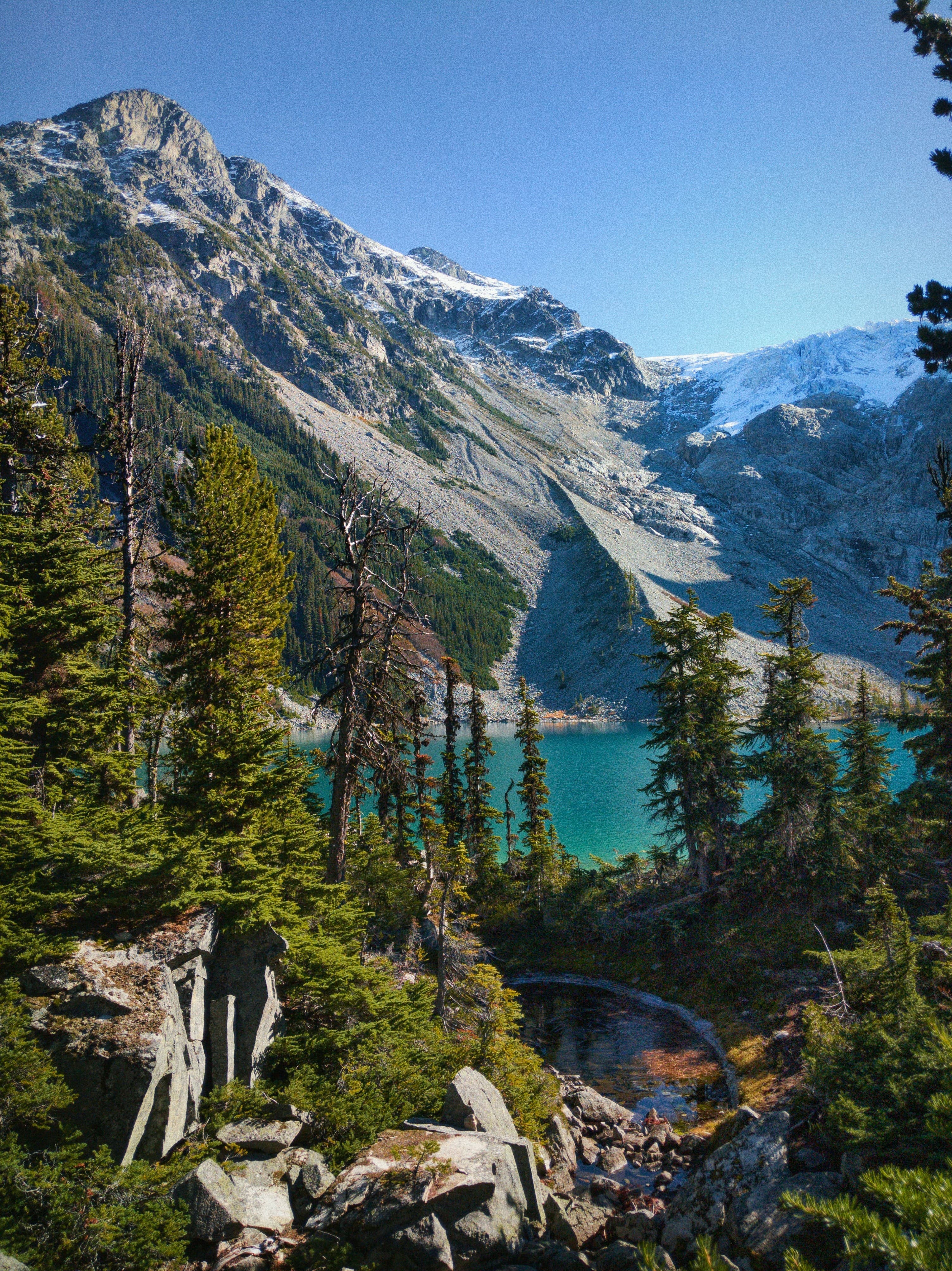 Mountain valley with turquoise lake through BC forest